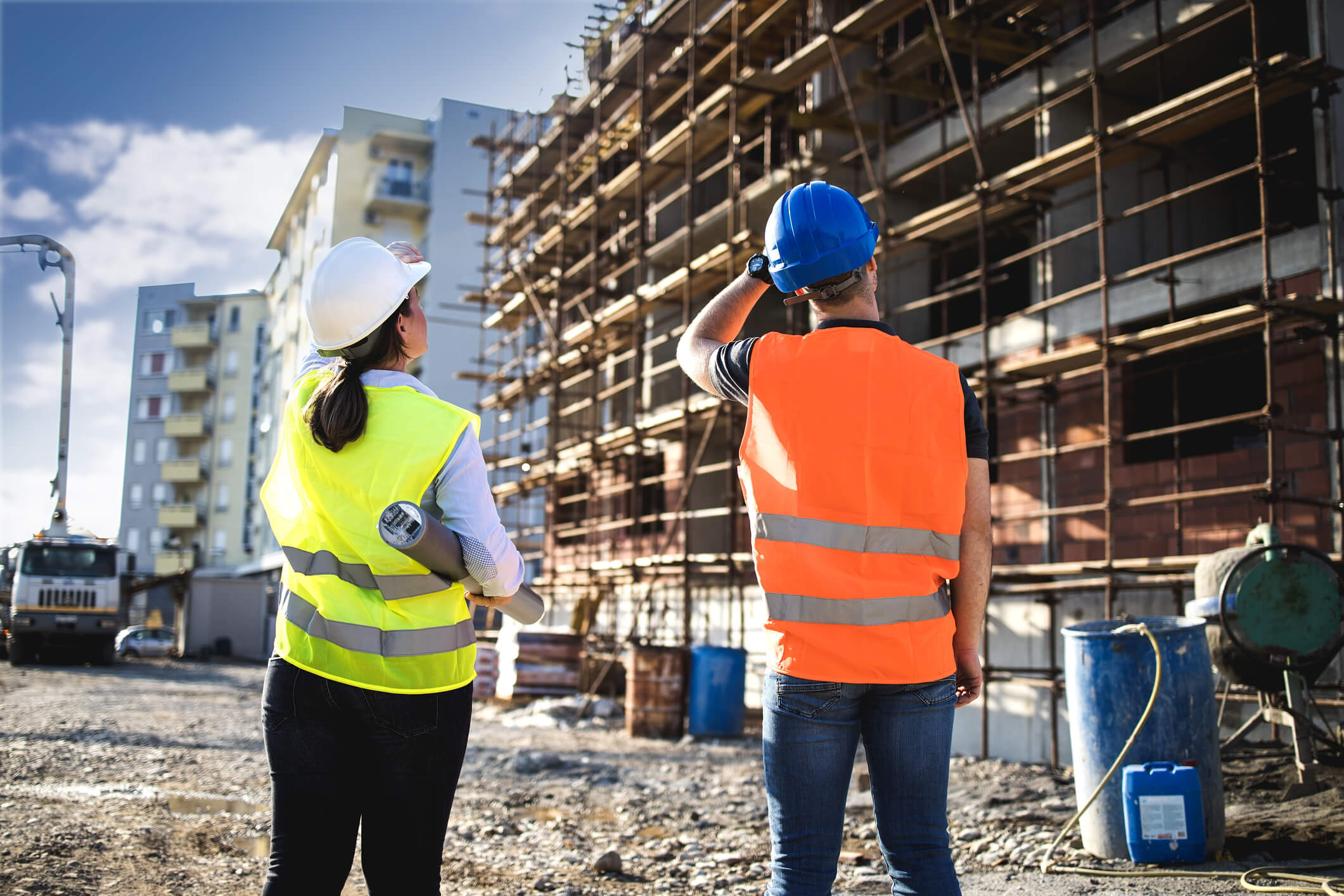 Man and woman talking at a construction site